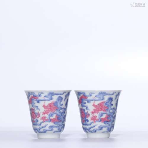 A PAIR OF RUBY-RED BLUE AND WHITE 'DRAGON' CUPS.QING DYNASTY
