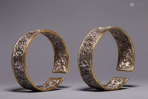 A pair of sterling silver and gold engraved character story ...