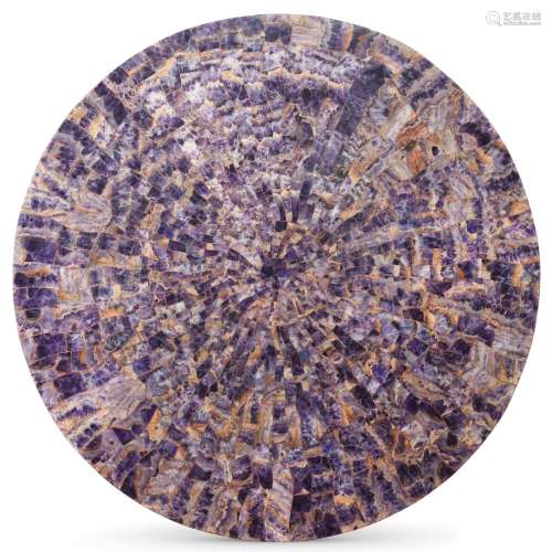 A circular amethyst veneered table top