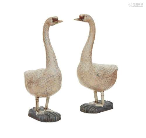 A pair of life size painted models of geese