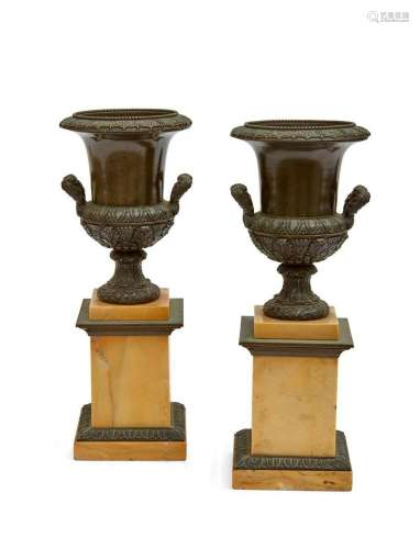 A pair of French bronze and marble urns