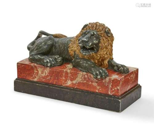 An Italian faux marble model of a recumbent lion