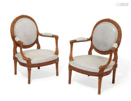 A pair of Louis XVI style walnut fauteuils