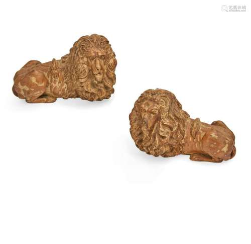 A pair of Italian pine models of recumbent lions