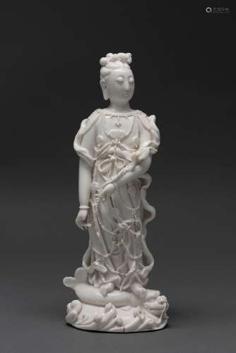 A CHINESE DEHUA STANDING FIGURE, EARLY QING DYNASTY, 17TH CE...