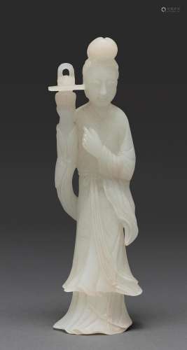 A CHINESE CARVED WHITE JADE STANDING FIGURE OF A FEMALE IMMO...