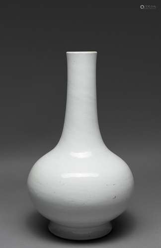 A CHINESE WHITE GLAZED BOTTLE VASE WITH ANHUA DECORATION, QI...