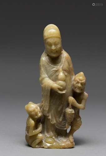 A CHINESE SOAPSTONE FIGURE OF A SCHOLAR AND TWO GHOSTS, QING...