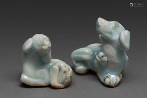 A RARE PAIR OF SMALL CHINESE QINGBAI FIGURES OF DOGS, SONG D...