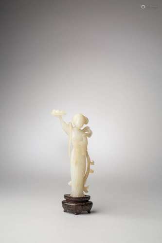 A CHINESE WHITE JADE FIGURE OF MAGU CARRYING A TRAY WITH THE...