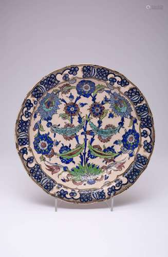 A QAJAR IZNIK-STYLE POTTERY DISH C.1897 Decorated with a sym...