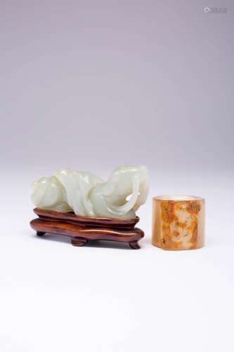 A CHINESE AGATE ARCHER`S RING AND A JADE CARVING OF A DOG LA...