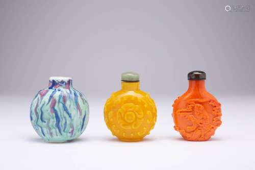 THREE CHINESE SNUFF BOTTLES LATE QING DYNASTY One porcelain,...