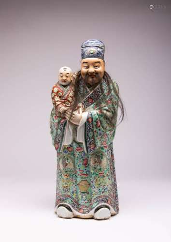 A LARGE CHINESE FAMILLE ROSE FIGURE OF AN IMMORTAL AND CHILD...