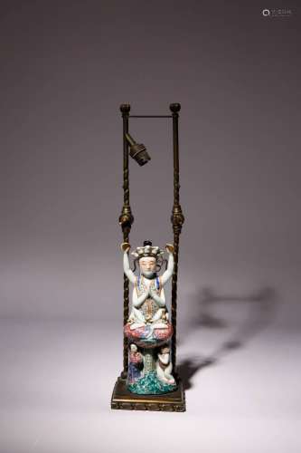 A CHINESE FAMILLE ROSE EIGHT-ARMED FIGURE OF GUANYIN LATE QI...