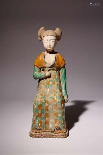 A CHINESE SANCAI POTTERY FIGURE OF A SEATED COURT LADY PROBA...