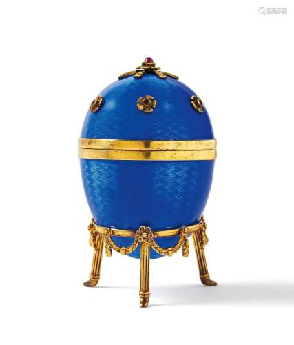 Decorative egg with violet blue enamel decor and set with ge...