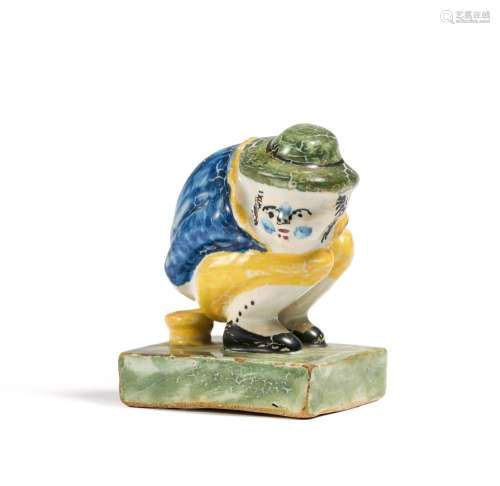 Small figurine of squatting man on chamber pot