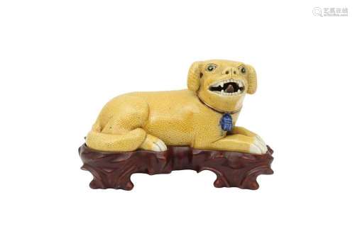 A CHINESE YELLOW-GLAZED MODEL OF A RECUMBENT DOG