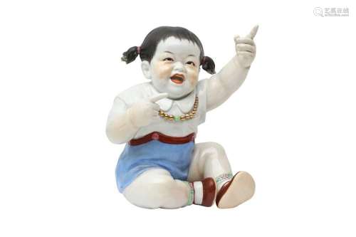 A CHINESE PORCELAIN FIGURE OF A GIRL