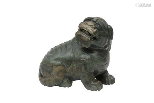 A CHINESE CELADON JADE MODEL OF A LION DOG