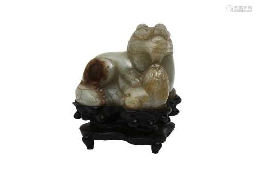 A CHINESE PALE CELADON JADE CARVING OF A LION DOG AND CALF