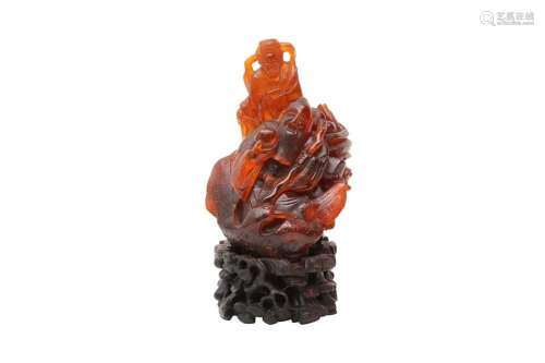 A CHINESE AMBER `IMMORTALS` CARVING