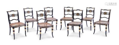 A SET OF SEVEN REGENCY EBONISED AND PARCEL GILT DINING CHAIR...