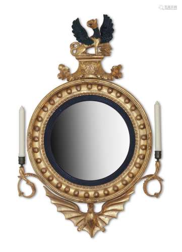 A REGENCY CARVED GILTWOOD CONVEX WALL MIRROR, IN THE MANNER ...