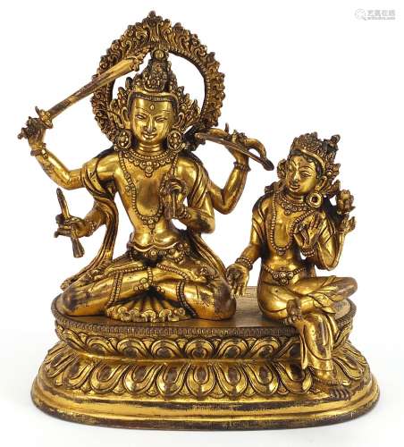 Chino Tibetan gilt bronze figure of two deities sitting on a...