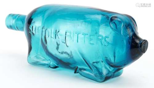 Blue glass bottle in the form of a pig advertising Suffolk B...