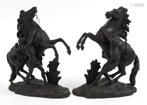 After Guillaume Coustou the Elder, Pair of patinated spelter...