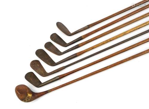 Seven early 20th century wooden and metal shafted golf clubs...