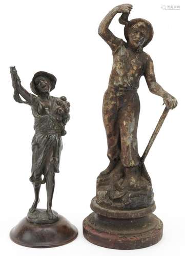 Two antique spelter figures of a miner and beggar boy, the l...