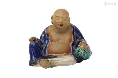 A CHINESE FIGURE OF A RECLINING BUDAI HESHANG