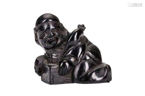 A JAPANESE EBONY NETSUKE OF A DAIKOKU AS A RAT-CATCHER SIGNE...