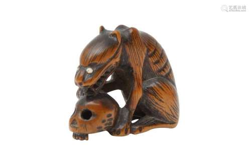 A JAPANESE WOOD NETSUKE OF A WOLF