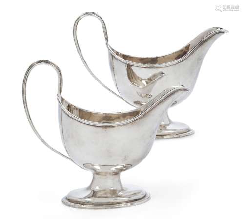 A pair of George III silver pedestal sauce boats, London, 17...