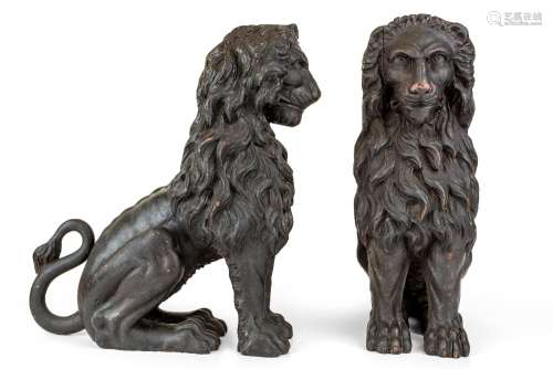 A pair of Italian carved wood models of seated lions