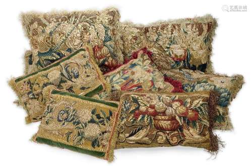 A group of eight tapestry cushions, 18th century and adapted...