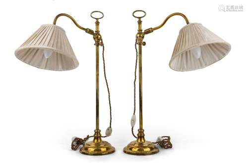 A pair of modern brass adjustable desk lamps, each with weig...