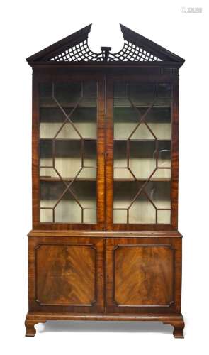 A George III mahogany bookcase, the carved and pierced broke...