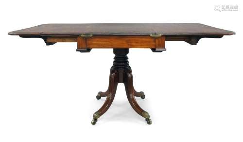 A Regency mahogany drop leaf dining table, with rosewood cro...