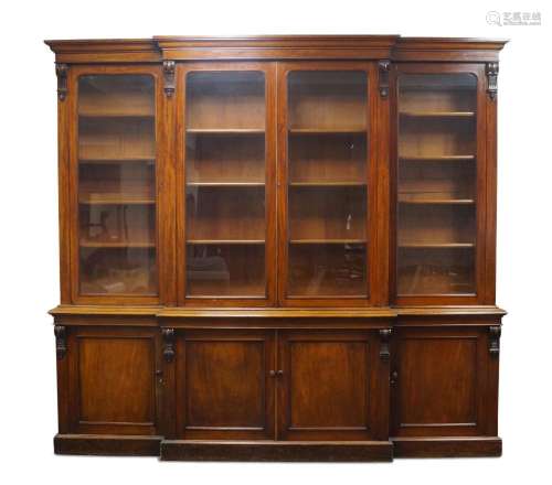 A Victorian mahogany breakfront library bookcase, the steppe...
