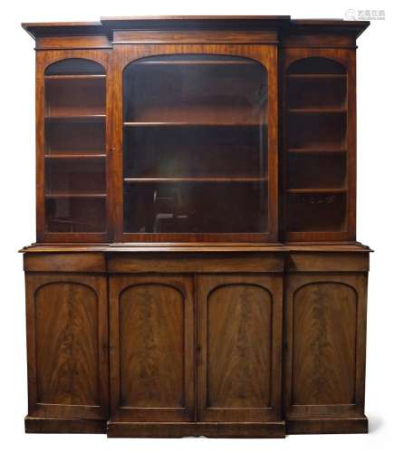 A Victorian mahogany breakfront library bookcase, the steppe...