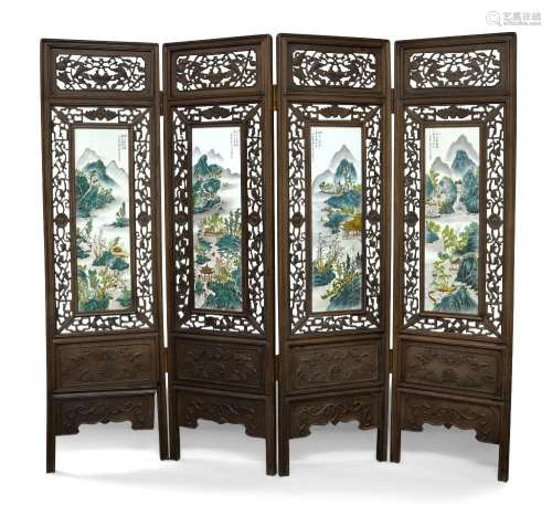 A Chinese hardwood and porcelain four fold screen, carved an...