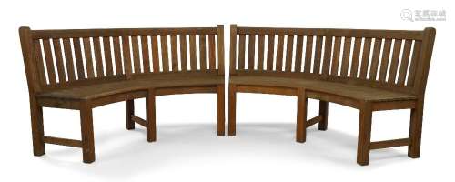 A pair of Westminster teak garden benches, of concave form, ...