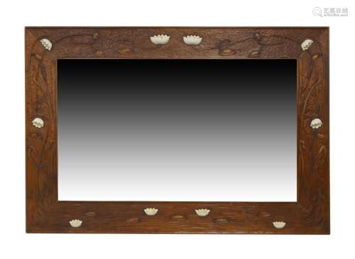 A large Arts and crafts carved walnut mirror, 20th century, ...