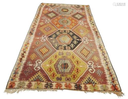 A large kilim carpet, 20th century, with four geometric meda...