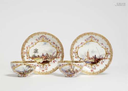A pair of Meissen porcelain tea bowls and saucers with lands...